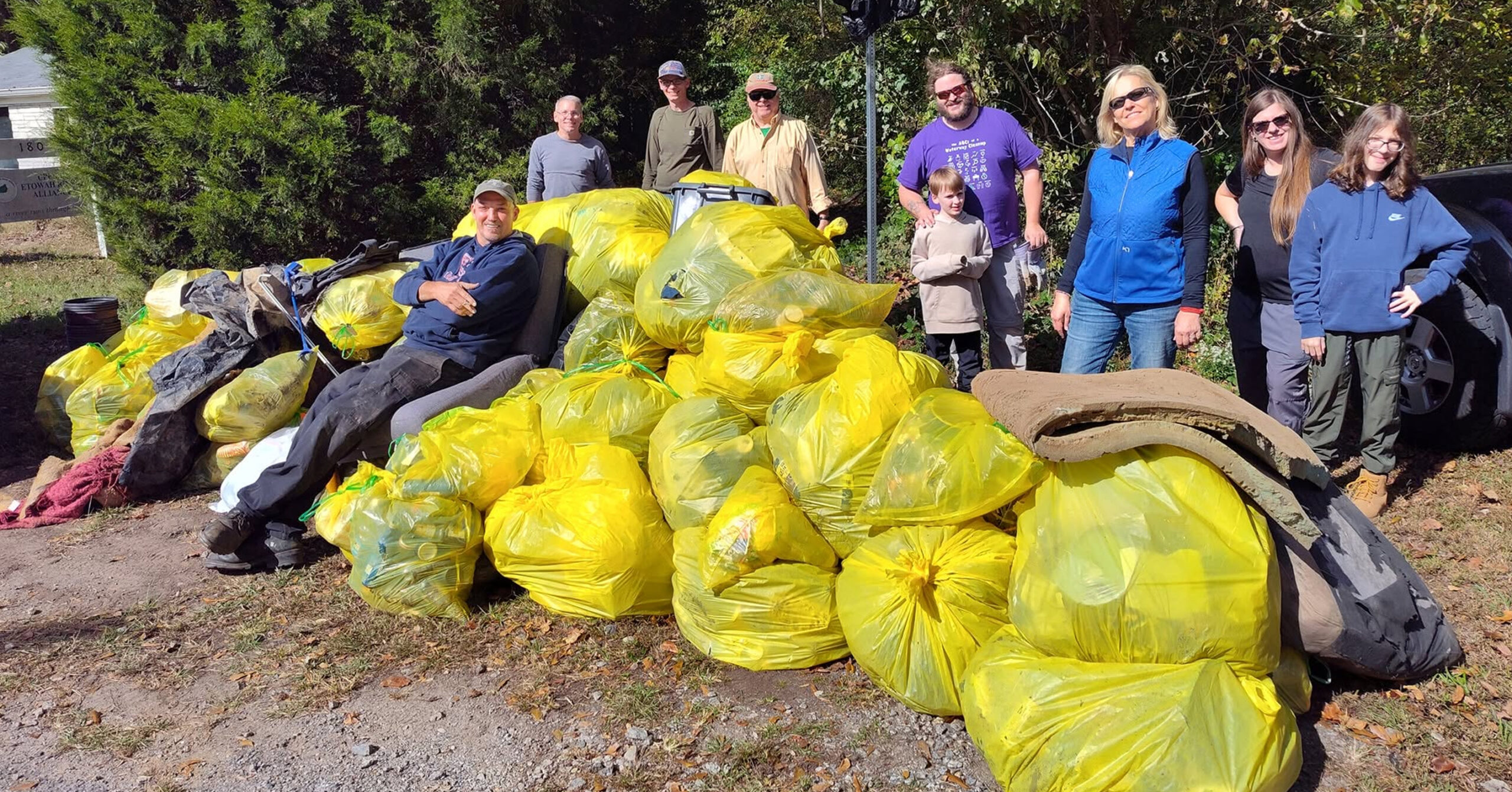 etowah-clean-up Volunteers with dozens of yellow trash bags collected at a cleanup
