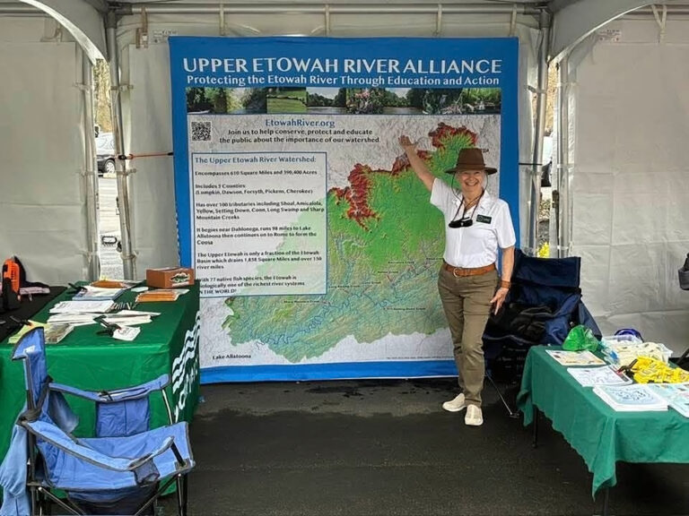 Laine Wood standing in front of our Upper Etowah River Alliance display