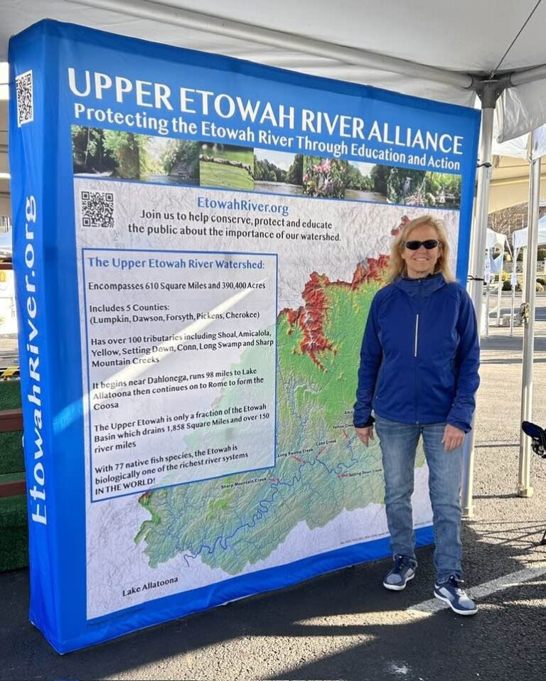 Mary Sorensen standing by the UERA event display